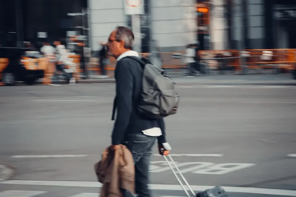 Traveller pulling a suitcase across a city street